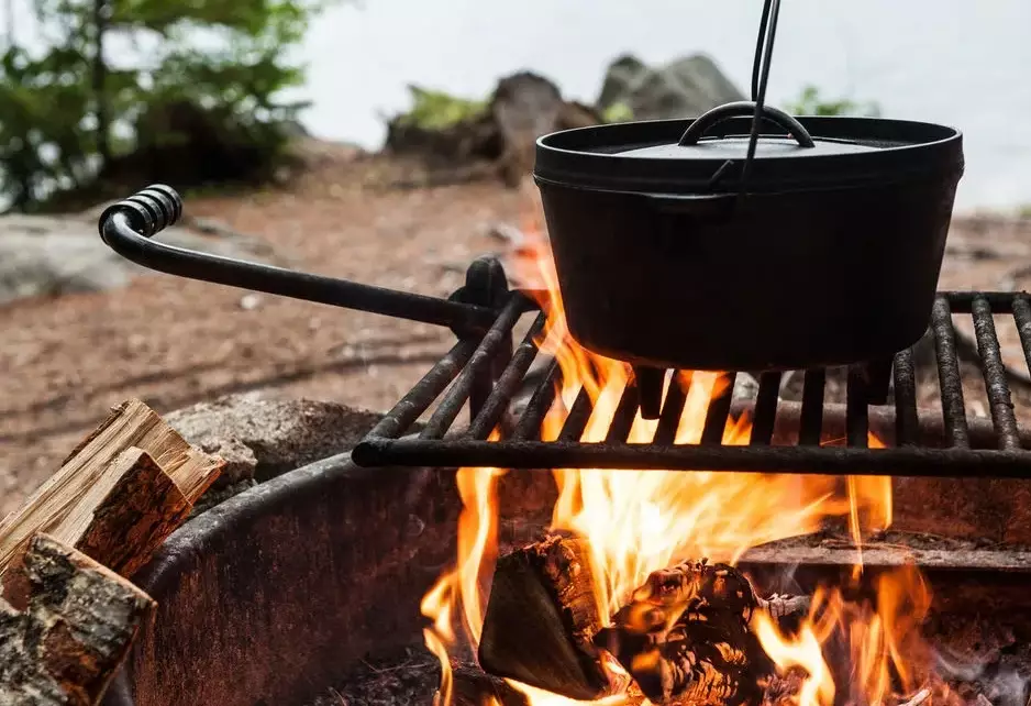 camping cooking over fire